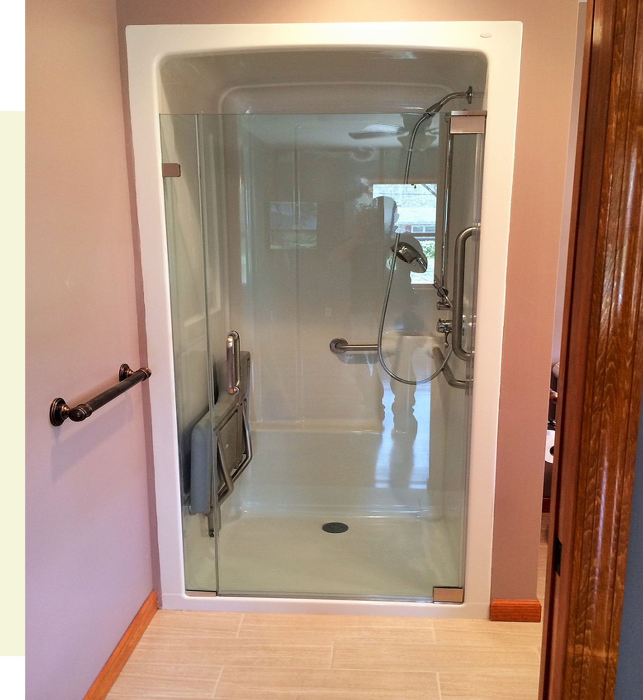Accessible shower with grab bars and seat.