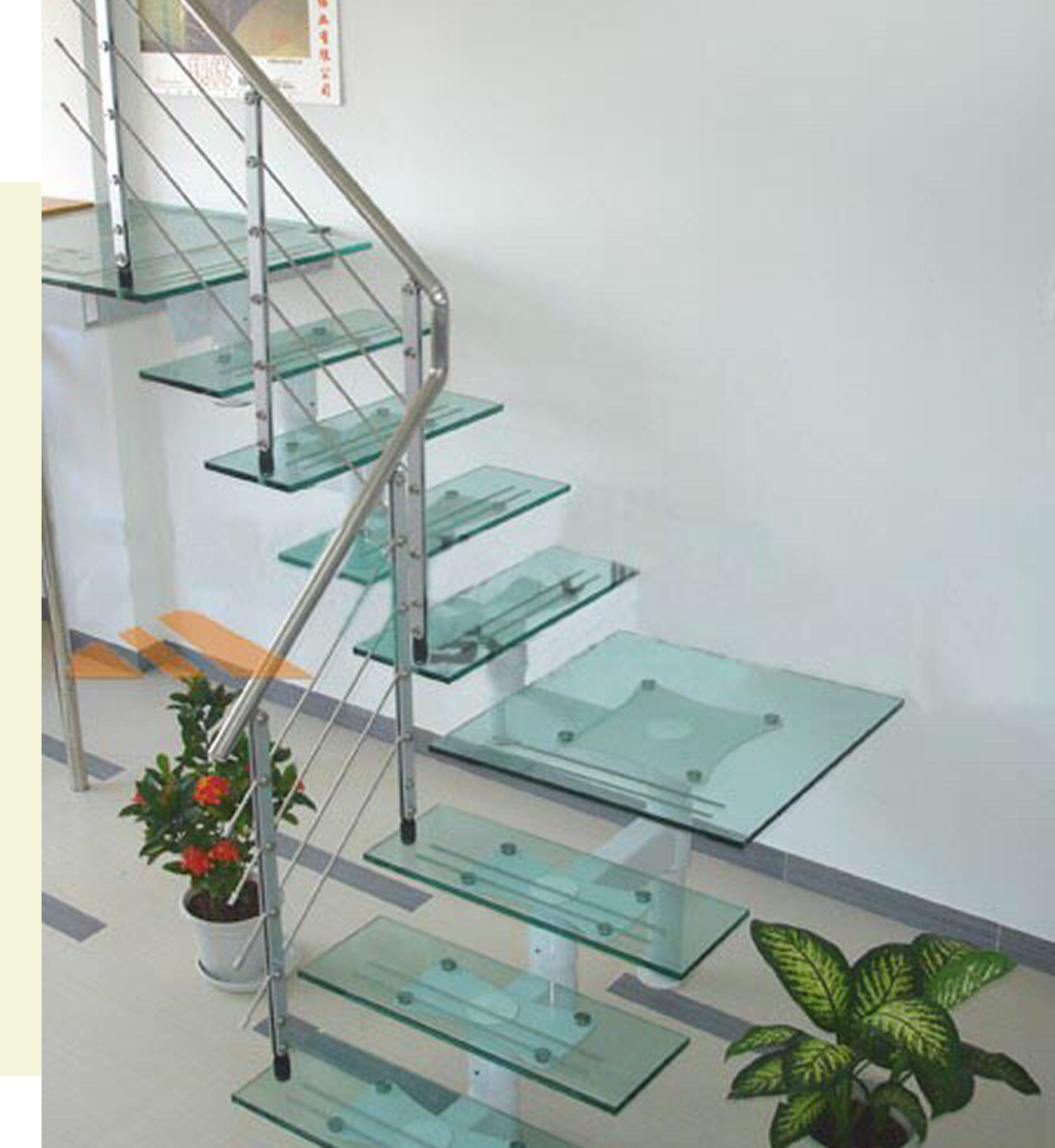 Modern glass staircase with metal railing.